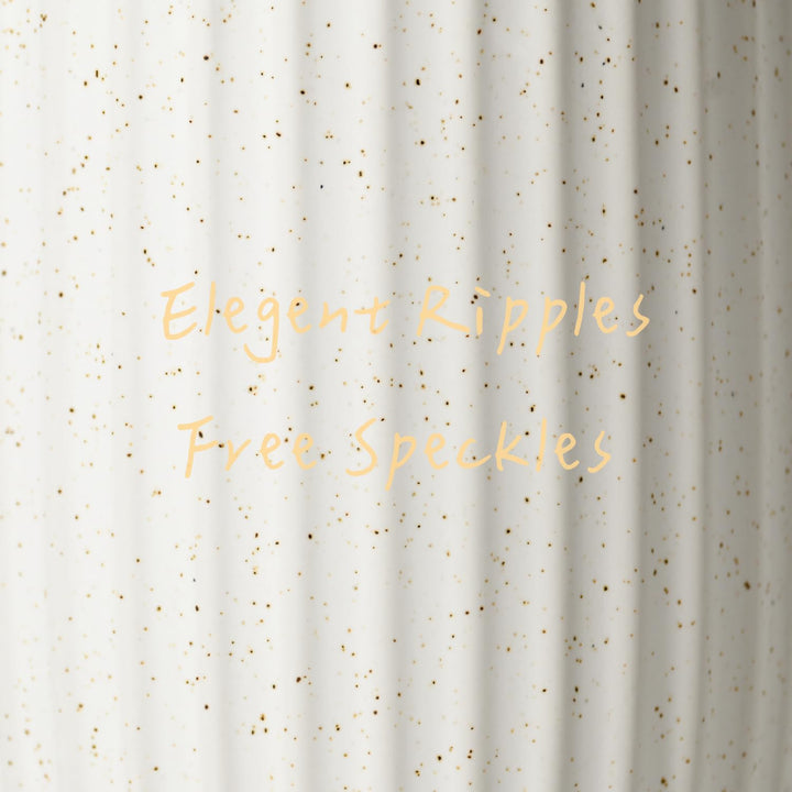 Close-up of the rippled white ceramic surface with fine gold speckles