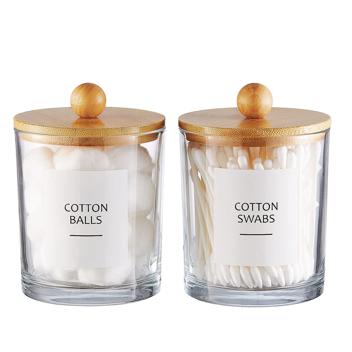 Two clear glass apothecary jars with bamboo lids, labeled and filled with cotton balls and cotton swabs