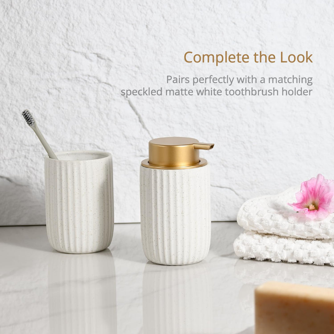 Ribbed speckled white soap dispenser beside a matching ribbed toothbrush holder on a white counter