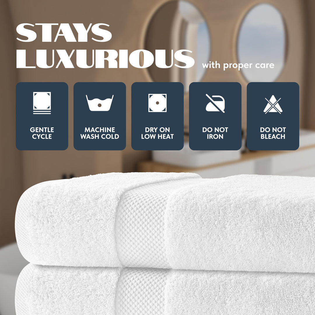 Folded white bath towels with care icons: gentle cycle, machine wash cold, dry on low heat, do not iron, do not bleach