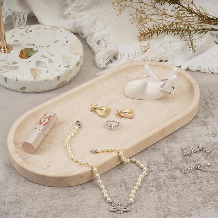 Travertine tray holding a pearl necklace, earrings and a lipstick on a dresser